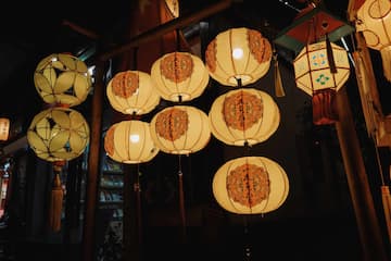 夜晚拍摄的多个灯笼，发出暖色光芒。