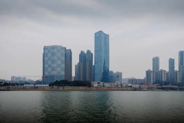 城市高楼林立水面平静天空阴沉建筑群倒影水中