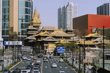 繁忙的城市街道 古建筑群与现代高楼并存 车辆行驶在道路上
