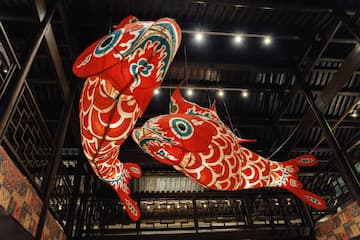 两只红色鲤鱼形状的灯笼悬挂在室内。